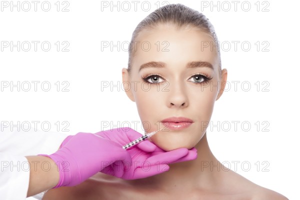 Beautiful face lip filler collagen injection Cosmetic spa beauty treatment with pink gloves, on white, Atlanta, USA, North America
