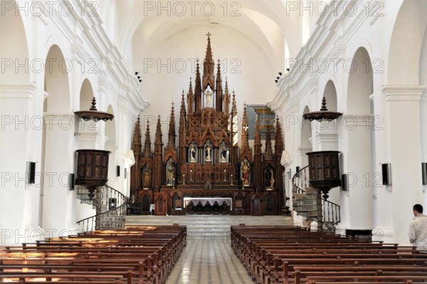 Interior of a church with Gothic altar and long pews for parishioners, Trinidad, Cuba, Central America