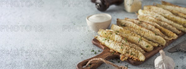 Baked Parmesan Garlic Zucchini. Ideas and recipes for easy and healthy lunch or dinner - oven baked zucchini. Copy space for text. Banner