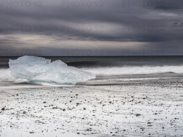 Diamond Beach, iceberg in the surf on the black lava beach, near Jökulsarlon glacier lagoon, Vatnajökull National Park, Hornafjörður, South Iceland, Iceland, Europe