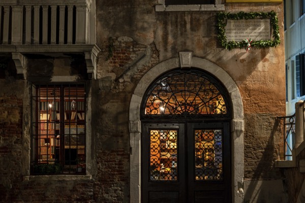 VENICE, ITALY, NOVEMBER 30, 2022, An old Book Store illuminated at Night, Venice, Italy, Europe