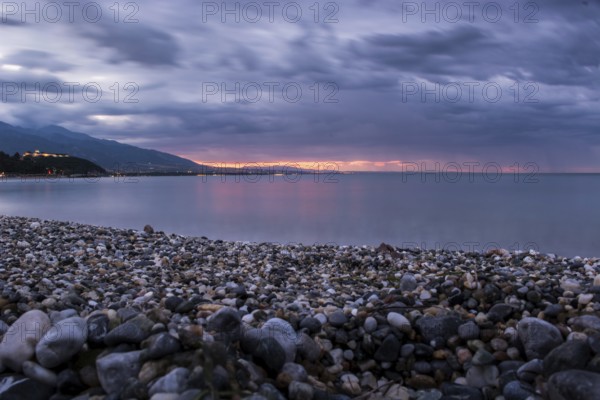 Beautiful seascape, amazing view of pebble coastline in mild sunset light, romantic evening on the beach, perfect place for summer holidays