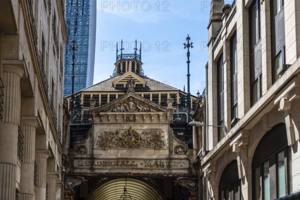 London, UK, May 14, 2019: Low angle view of the entrance to Leadenhall Market. Originally a meat, poultry and game market, it is now home to a number of boutique retailers, restaurants and cafes