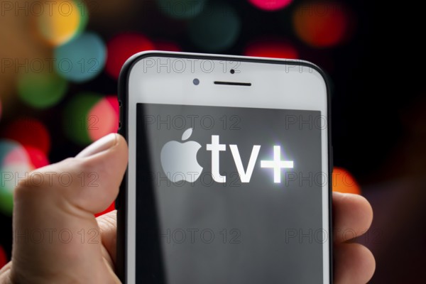 Calgary, Alberta, Canada. May 21, 2020. A person holding a white iPhone Plus with the Apple TV Plus logo on the screen