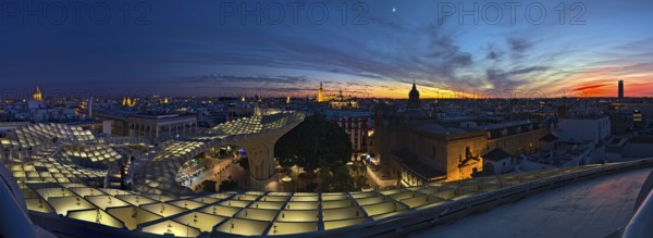 Sunset view on Sevilla from Setas de Sevilla, an architectural monument with viewing platform. The sky was very colorful at this time and illuminates the sky in different shades of blue and red