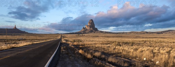 Scenic clouds above a straight road through Navajo Nation, USA, North America