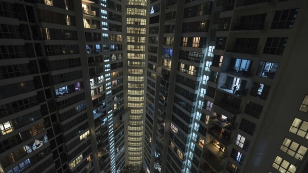 Lights in the windows of high-rise apartment block at night. Kuala Lumpur, Malaysia, Asia