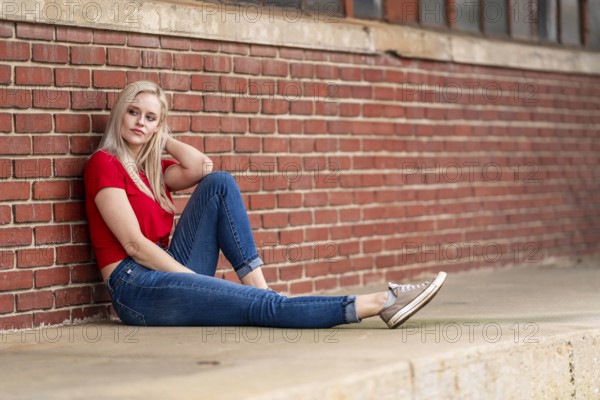 A beautiful blonde woman poses joyfully for the camera, showcasing her stylish spring clothing. With a bright smile and playful demeanor, she radiates happiness, embracing the upcoming gorgeous weather, Charlotte, United States of America