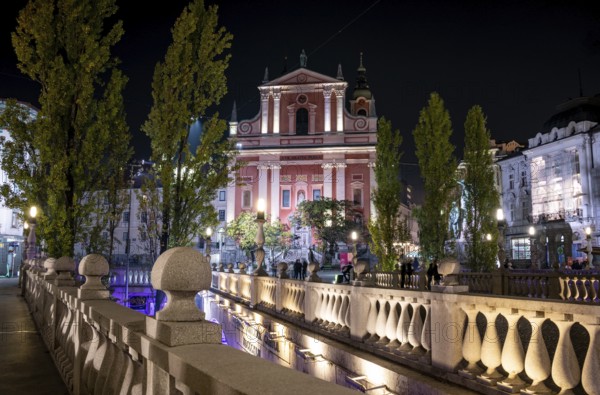 Famous Three Bridges and the Preseren square in the center of Ljubljana illuminated at night, Slovenia, Europe
