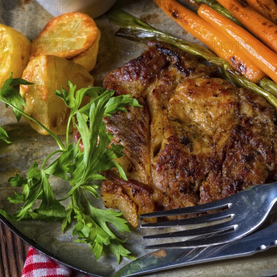 Grilled steak with vegetables and fried potatoes