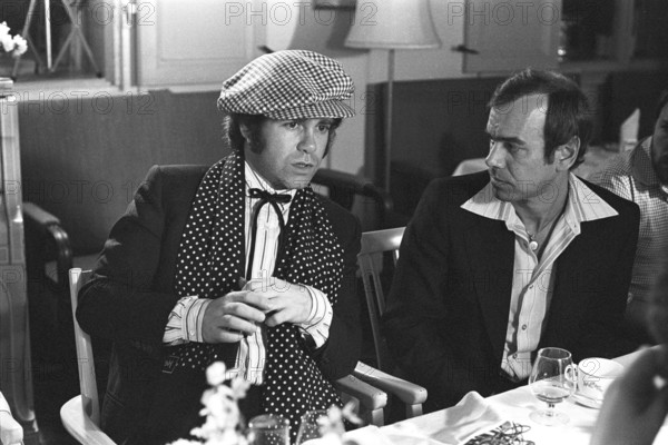 Elton John. English singer, songwriter born march 25 1947. Pictured wearing a chequered cap and a matching chequered scarf during a visit to Sweden 1978