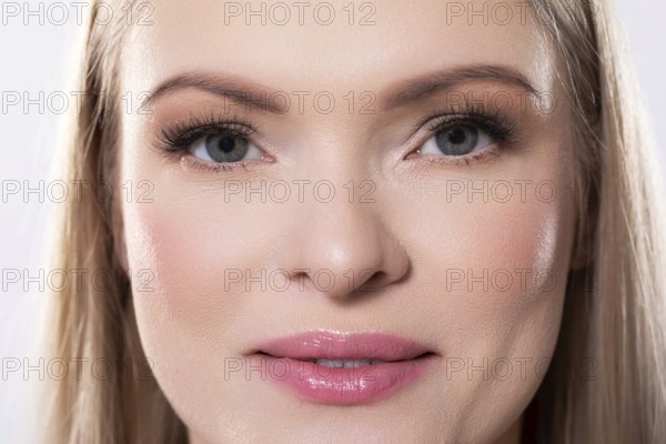 Closeup of an absolutely stunning woman displaying her radiant skin along with her pristine and striking features