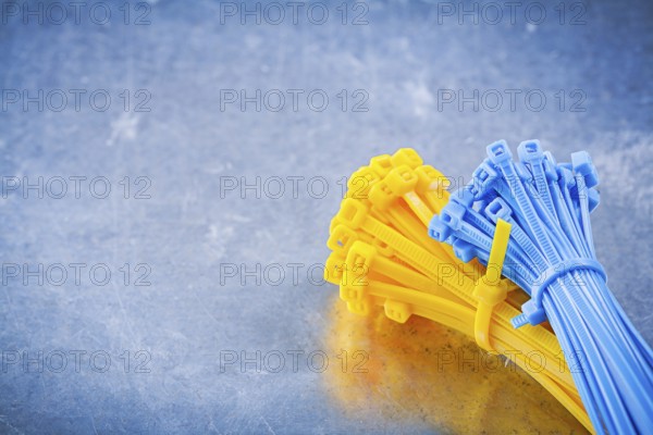 Set of cable ties on metallic background construction concept
