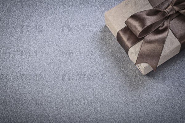Wrapped gift box on grey background celebrations concept