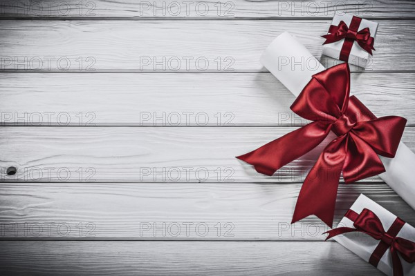Paper roll with red ribbon present boxes holidays concept