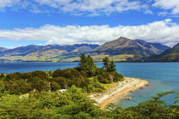 The beautiful lake Wanaka in New Zealand. The picturesque shore of Lake Wanaka. South Island. Cirrus clouds fly in the sky. Concept of active and photo tourism