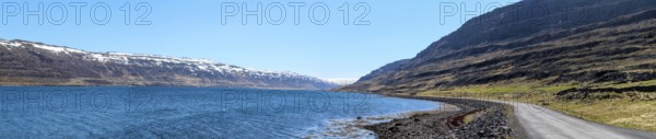 Panoramic view of a gravelled road at a fjord, Westfjords of Iceland