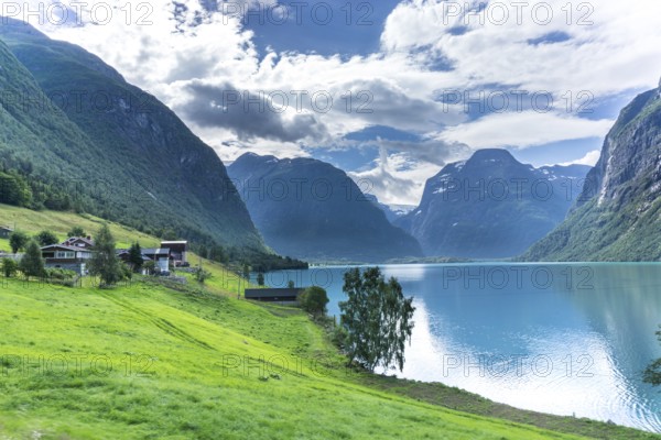 The Kjenndalsbreen is part of the Jostedalsbreen, one of the largest glaciers in Norway, and forms an impressive mountain landscape with a beautiful lake in Sande. The glacier Kjenndalsbreen with a lake in Norway is a beautiful place to travel to in summertime