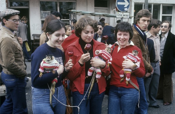 London 1982. A London street view and three young women with monkeys. Credit Roland Palm