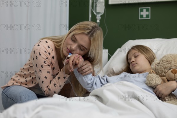 A heartfelt and nurturing moment shared between a caring mother and her daughter inside a hospital room