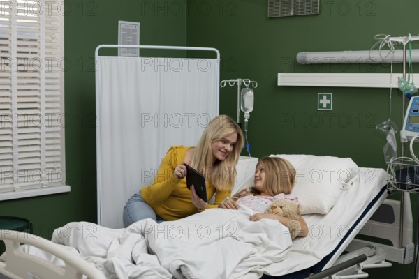 A touching and caring moment shared between a devoted mother and her beloved child within a hospital setting