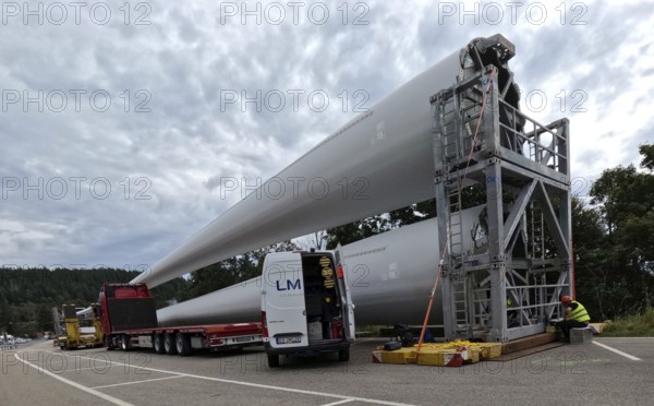More rotor blades for the Schauinsland wind farm are ready for assembly at the car park on the Feldberg pass The heavy transport of the 68-metre-long rotor blades leads over the Feldberg (Breisgau-Hochschwarzwald district) to Freiburg's local mountain, the Schauinsland The rotor blades are mounted on a self-propelled vehicle and the journey to their destination takes several days at walking pace Themed picture Wind energy, Feldberg in the Black Forest, Germany, Europe
