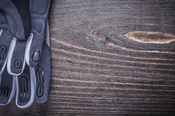 Working protective gloves on wood board copyspagardening concept