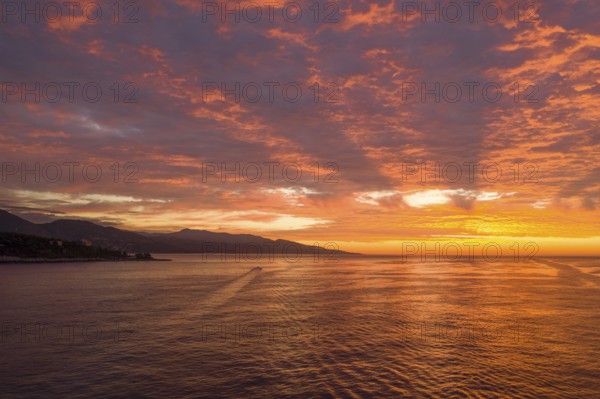 Aerial view of sunrise at Cap Martin, behind the Italian Ligurian coast, Roquebrune Cap Martin, Alpes Maritimes department, Provence-Alpes-Cote d'Azur region, France, Mediterranean Sea, Europe