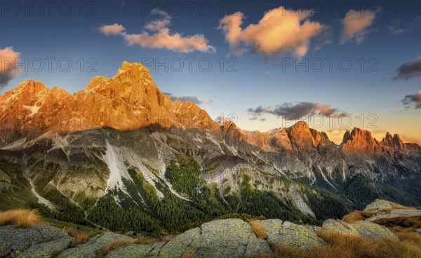 Cimon delle Pala mountain above Passo Rolle with red clouds at sunset