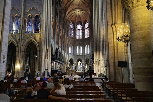 Cathedral Notre-Dame de Paris, Ille de la Cité, 4th arrondissement, Paris, France, Europe, Interior of a gothic cathedral with high ceilings, stained glass windows and pews, people sitting and looking at the church, Europe