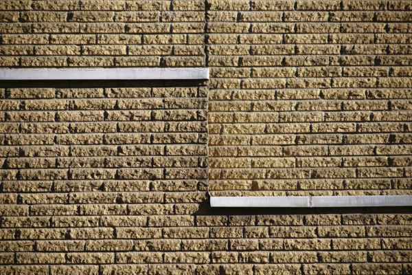 Close-up of a clinker brick façade made of rough stones on the façade of a building