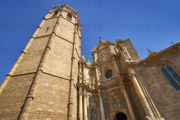 Valencia Cathedral main door and Miguelete tower at Plaza de la Reina sq Spain