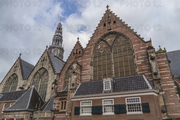 Gothic church with impressive windows and towers under a cloudy sky, Amsterdam, Netherlands
