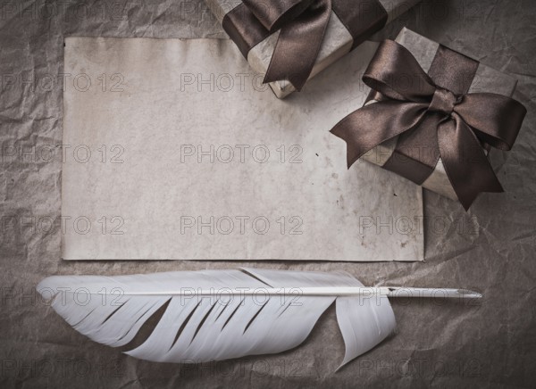 Wrapped present boxes sheet of wrapping paper plume celebration concept