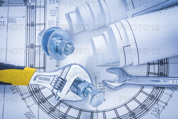 Adjustable key spanner bolts nuts and blueprints construction concept