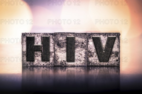The word HIV written in vintage ink stained letterpress type