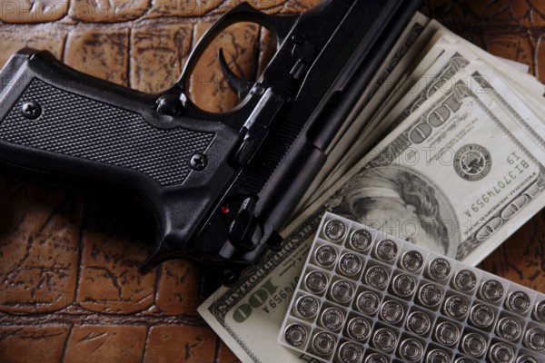 Dollar notes and gun, black pistol, mafia inspiration