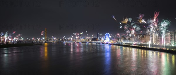 Panorama of City Düsseldorf at Silvester with fireworks and River Rhein