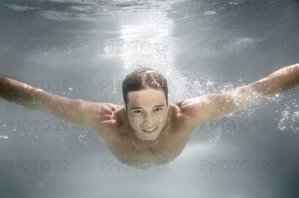 An image of a man diving in a pool