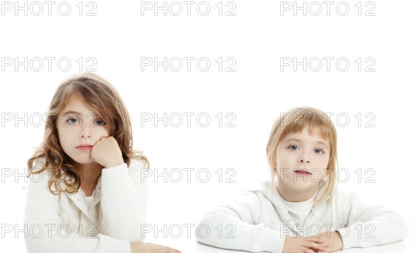 Blond and brunette kid girls portrait on white desk table