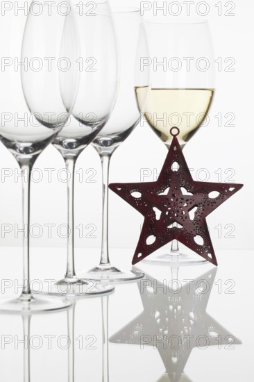 Four glasses of wine and Christmas decoration on the white background