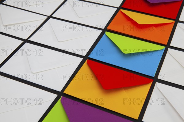Composition with white and colored envelopes on the table. The photo suitable for various holidays and anniversaries