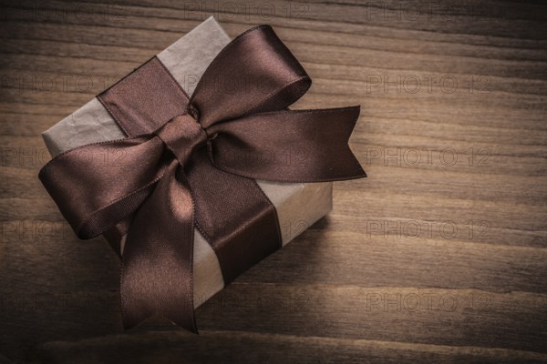 Wrapped gift on vintage wood board horizontal view holidays concept