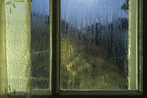 Moonlight through the window. Sweaty glass
