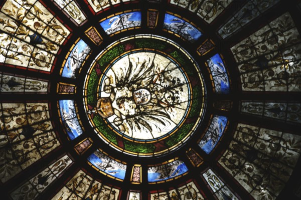 Bad Homburg, Germany - May 19, 2018: The colourful motif-painted windows of the entrance dome of the Kaiser-Wilhelm-Bad in the spa garden on 19 May 2018 in Bad Homburg