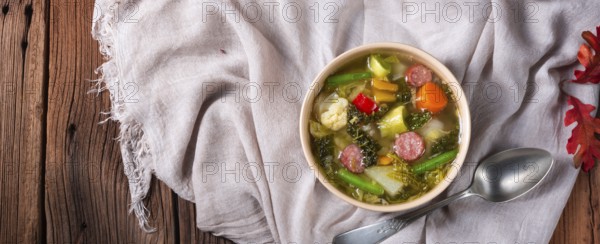 Delicious autumn vegetable soup with sausage and bacon