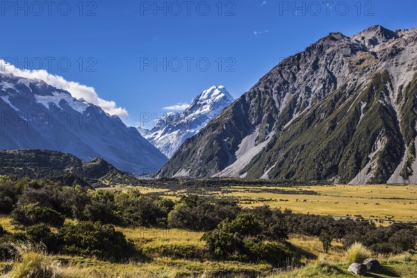 The concept of active, walking and photo tourism. The top of the mountain is covered with eternal snows. The highest mountain in New Zealand is Aoraki, or Mount Cook