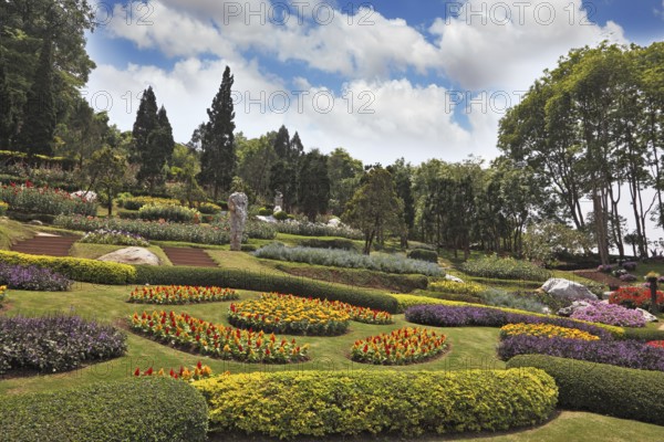 Tropical park and artly decorated flower beds. Huge picturesque landscape park in Thailand
