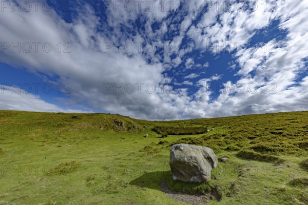 Vast rolling mountain landscape with a cliff and lush green meadows and dramatic skies on the edge of Snowdonia National Park, Penmaenmawr, Dwygyfylchi, Caernarfonshire, Conwy County Borough, Wales, United Kingdom, Europe