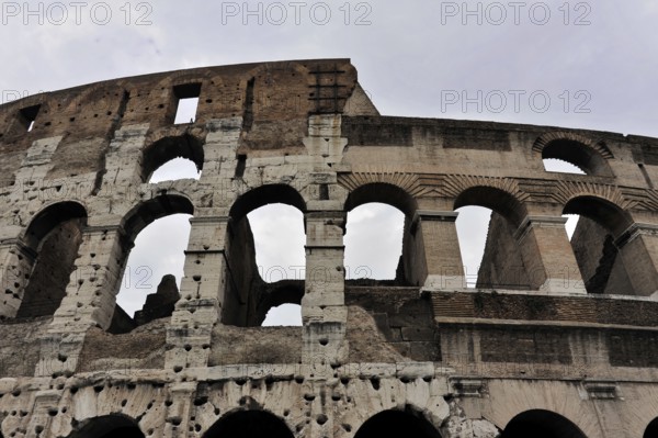 Colosseum, Colosseum, amphitheatre, built in 72 AD by Vespasian, Rome, Lazio, Italy, Exterior view of the ancient stone arches of the Colosseum in Rome, Rome, Lazio, Italy, Side view of the Colosseum showing the worn stone structure and majestic arches, Vatican, Rome, Lazio, Italy, Europe